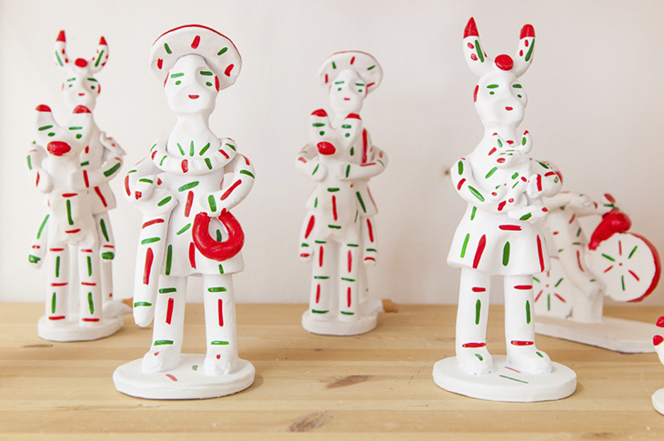 Siurells turn clay into traditional whistle figures painted white, red, and green Siurells turn clay into traditional whistle figures painted white, red, and green