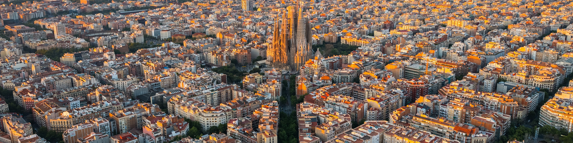 Aerial view of Barcelona with the Sagrada Familia in the center, showcasing a blend of history, architecture, modernity, and innovation