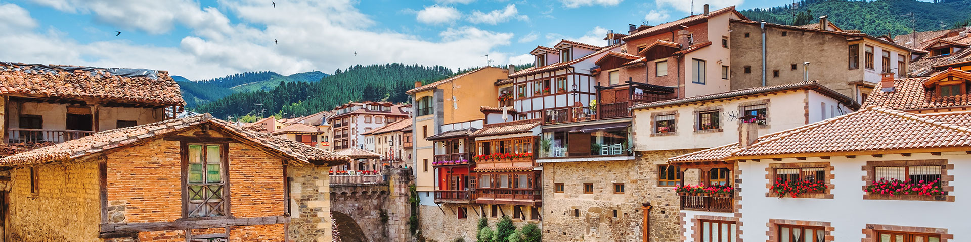 Cantabria brings together some of the most beautiful towns in northern Spain. Image: the famous hanging houses of Potes, over the Deva River