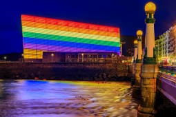 Image of the Kursaal Congress Centre and Auditorium in San Sebastián, adorned with a rainbow flag