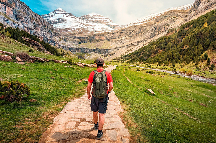 Trail through the meadow of Ordesa National Park towards the Cola de Caballo waterfall, amid the natural beauty of the Pyrenees in Huesca (Aragón) Trail through the meadow of Ordesa National Park towards the Cola de Caballo waterfall, amid the natural beauty of the Pyrenees in Huesca (Aragón)