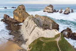 Aerial view of the rock formations and cliffs along Portio Beach (Costa Quebrada Geopark)