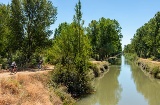 Cyclists traveling along part of the Canal of Castilla route around Valladolid Cyclists traveling along part of the Canal of Castilla route around Valladolid