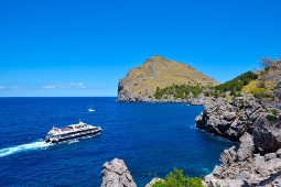 Small cruise ship arriving at the cove of Sa Calobra in the municipality of Escorca (Mallorca, Spain)