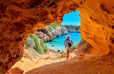 Over time, nature-based cultural activities and visits to the island's stunning coves (pictured, Cala des Moro) have replaced the nightlife tourism Over time, nature-based cultural activities and visits to the island's stunning coves (pictured, Cala des Moro) have replaced the nightlife tourism